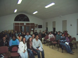 Diverse group of people attending a Christian training seminar in church fellowship hall