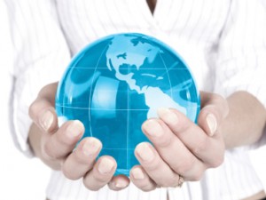 Hands holding globe representing Living Oasis Ministries mission to reach Muslims worldwide with the gospel